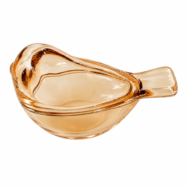 A small bird-shaped glass dice dish in a translucent amber or peach-tinted glass, photographed on a plain white background.