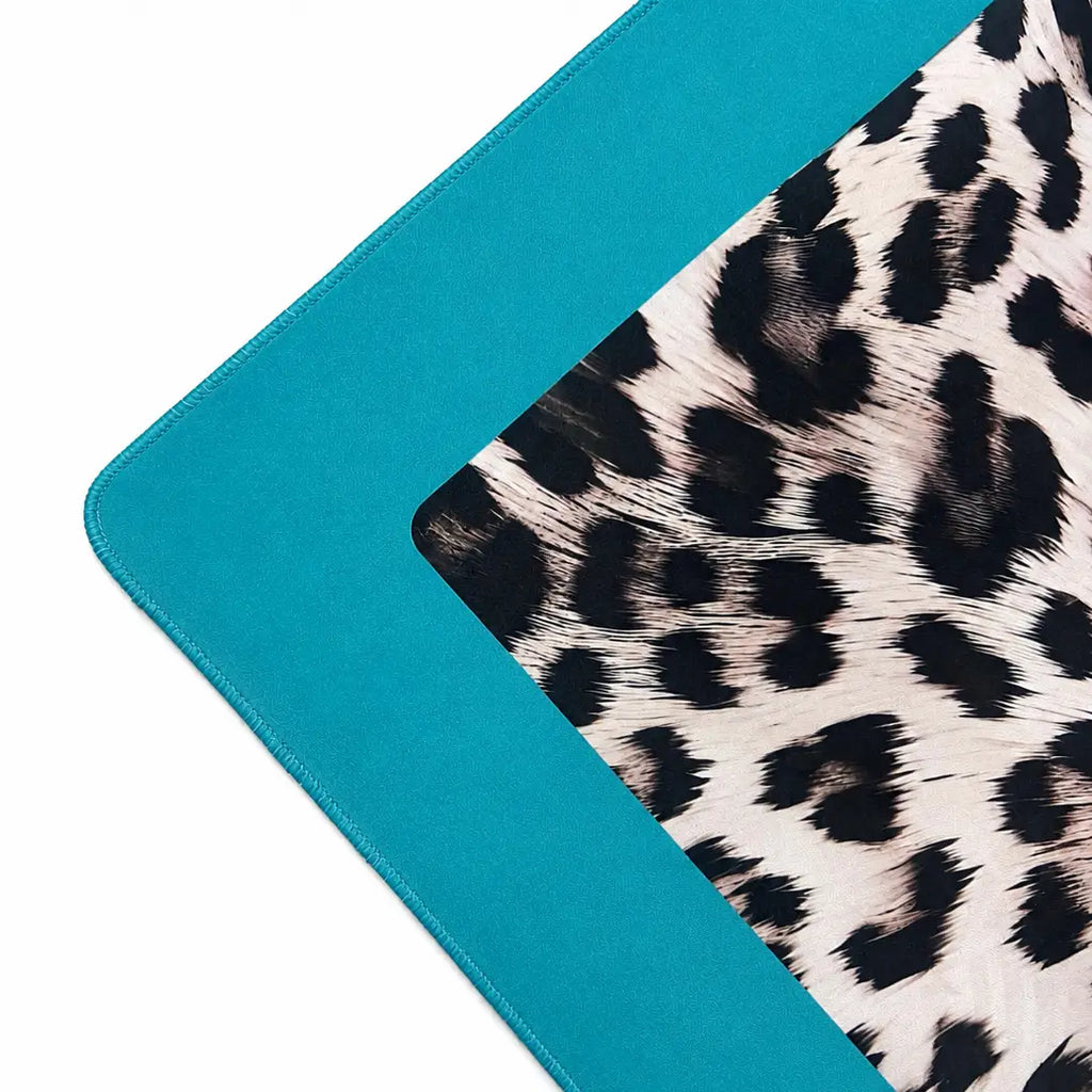 A square mahjong mat featuring black and white leopard print pattern in the center, surrounded by a solid teal border on a white background.