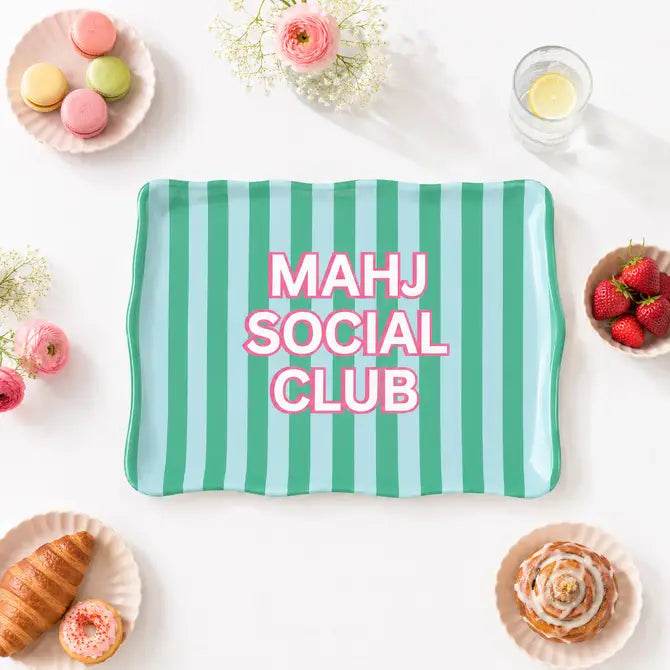 A rectangular serving tray with wavy edges, featuring vertical mint green and light blue stripes, with the text 'MAHJ SOCIAL CLUB' printed in pink with a white outline. 