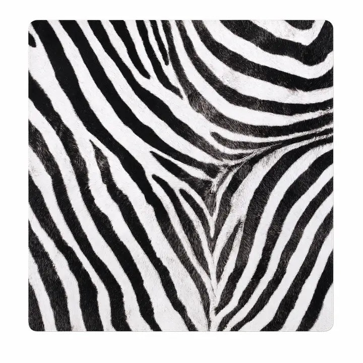 This is our Zebra Noir Safari Club Collection 33" Premium Mahjong Mat. Made from thick 3mm padded neoprene, it provides a smooth surface that lets tiles glide easily while helping soften the sound of play and protect your tabletop. The stitched edges add a clean, finished look and help the mat hold up beautifully through years of Mahjong.